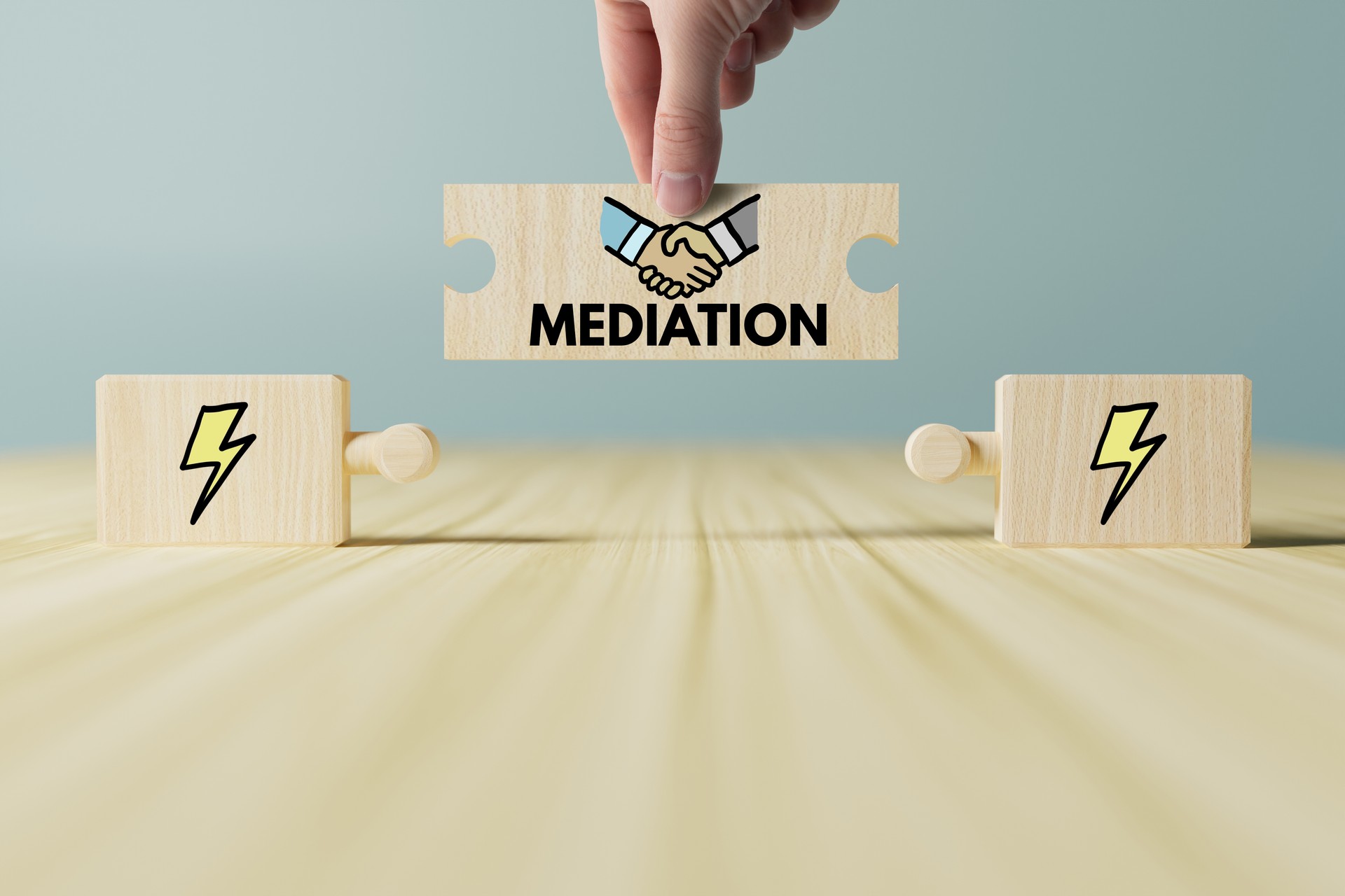 Wooden puzzle with icons of man and woman and mediation.