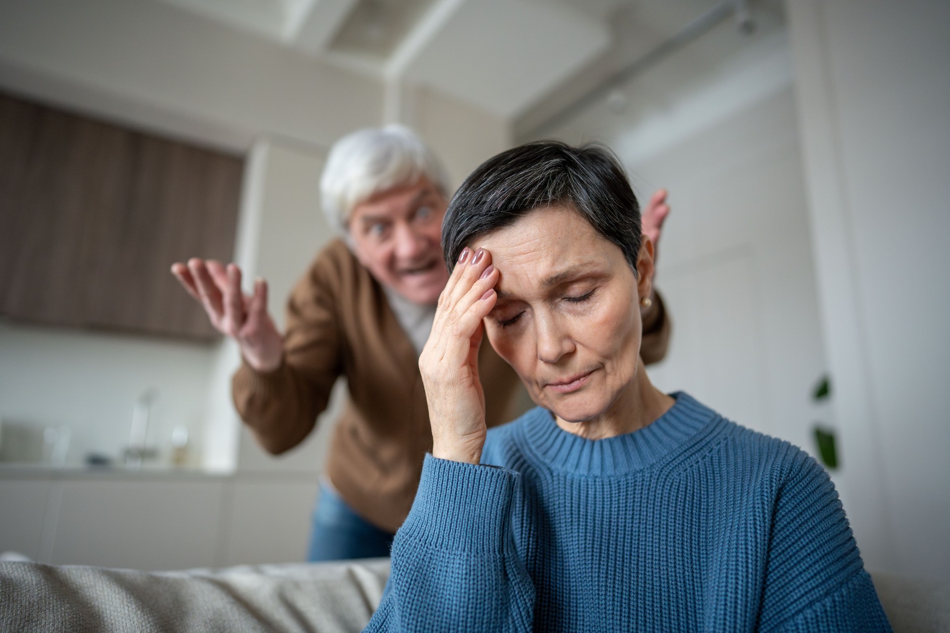 Tired exhausted wife bearing constant verbal attacks in toxic relationship, domestic tension Tired exhausted wife bearing constant verbal attacks in toxic relationship, domestic tension